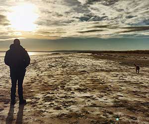 walking on beach with dog